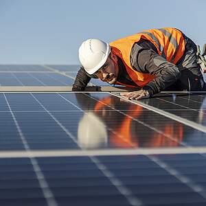 Un ouvrier contrôle une installation solaire sur le toit